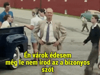 a man in a suit and tie is standing in front of a group of people on a street with a caption in a foreign language