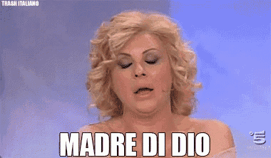 a woman with a ring on her finger wipes her face with her hand and says " madre di dio "