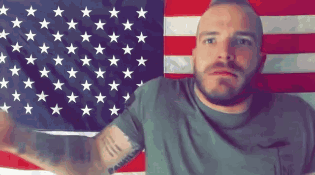 a man stands in front of an american flag with stars