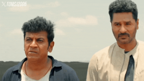 two men are standing next to each other in a movie scene with the year 2005 on the bottom
