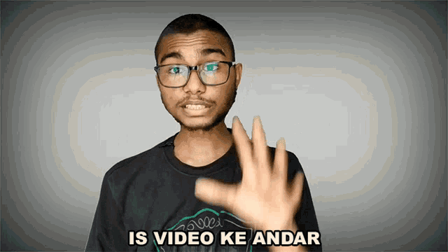 a man wearing glasses says " is video ke andar " with his hand