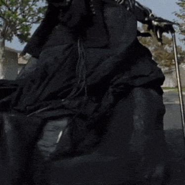 a large black object is sitting on the ground