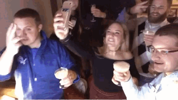 a group of people toasting with champagne glasses and a man taking a picture