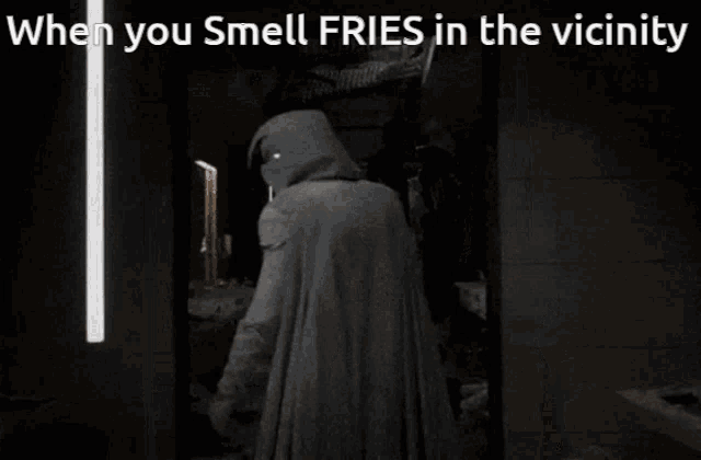 a man in a hooded cape stands in front of a mirror with the caption when you smell fries