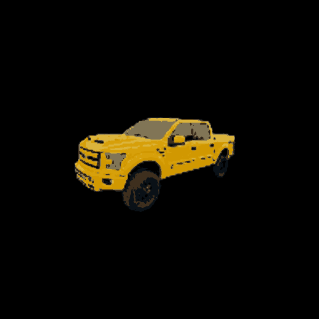a yellow truck with a large tire on the side