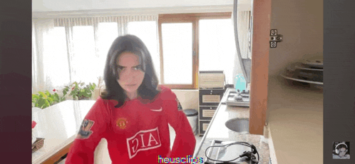 a woman in a red shirt with the letter p on it