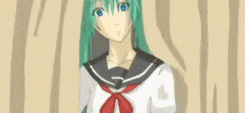 a close up of a girl with green hair and blue eyes looking at the camera .