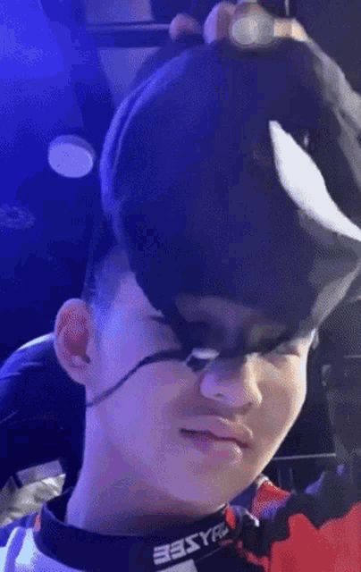 a man wearing a mask and a hat is making a face .