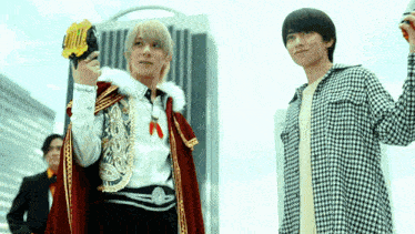 a man in a plaid shirt is standing next to a man in a cape