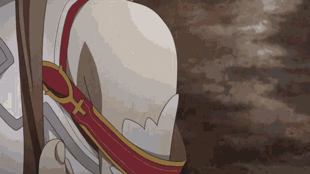 a close up of a person 's shoulder with a red and gold ribbon around it