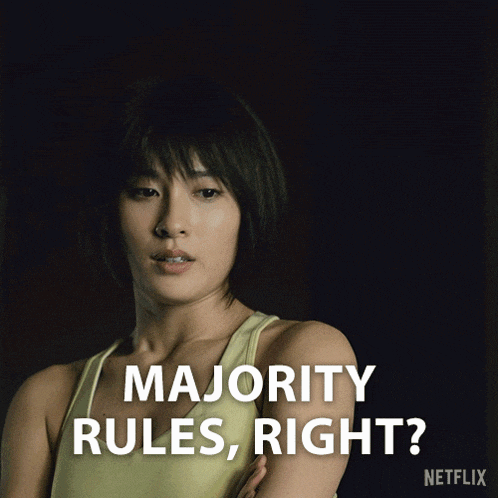 a woman in a yellow tank top with the words majority rules right on the bottom