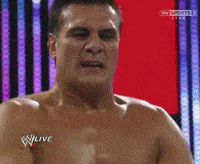 a man without a shirt is making a funny face in front of a sky sports sign