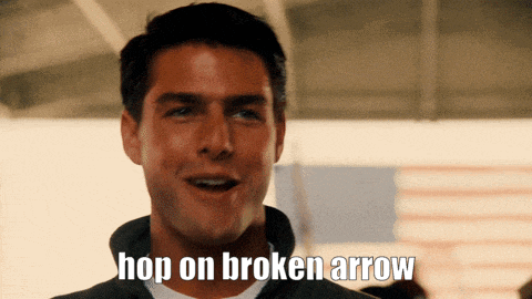 a man says hop on broken arrow in front of a flag