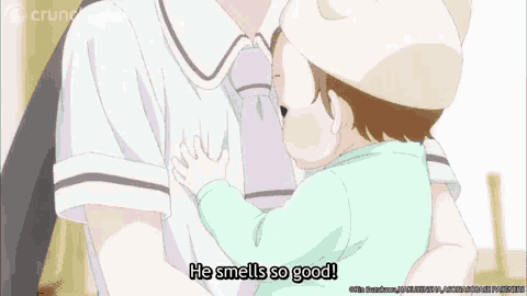 a baby is being held by a person and the baby says he smells so good