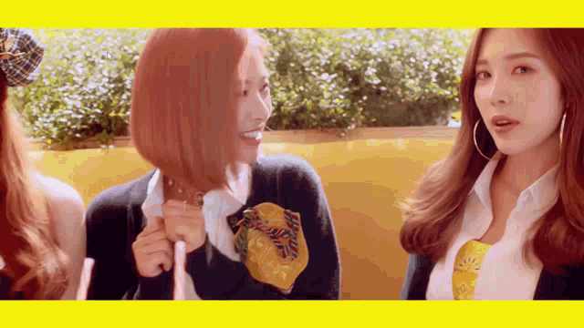 a woman with red hair is holding a fried chicken while another woman looks on