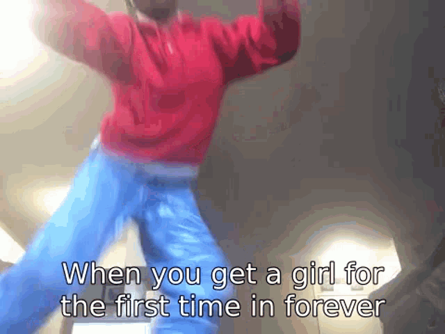a man in a red sweater and blue jeans is dancing with the words when you get a girl for the first time in forever