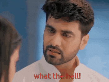 a man with a beard is looking at a woman and says what the hell !