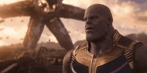thanos from avengers infinity war stands in front of an alien