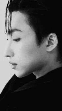 a black and white photo of a man 's face and neck