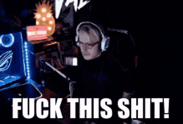 a man sitting in front of a computer with the words fuck this shit