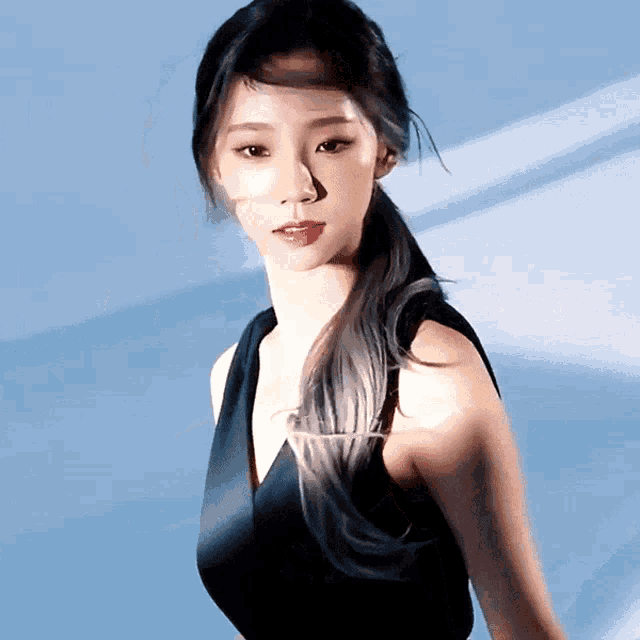 a woman with a ponytail is wearing a black dress