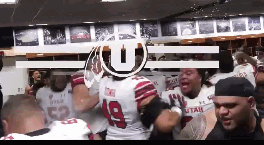 a group of utah football players are standing in a locker room