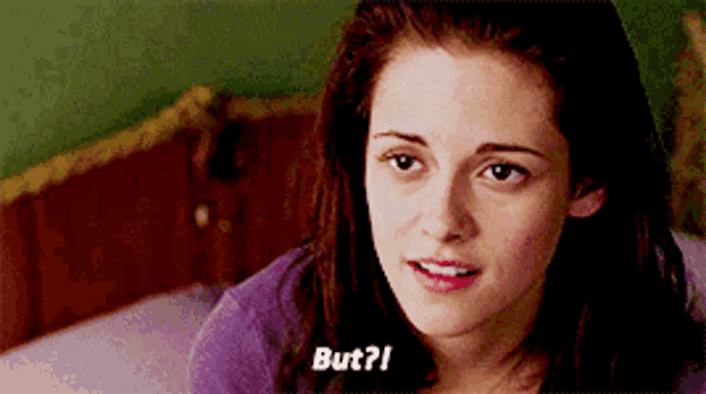 a woman in a purple shirt is sitting on a bed and says but ?