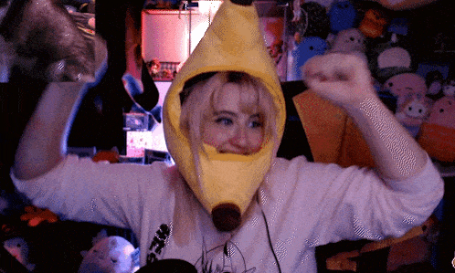 a girl wearing a yellow banana hat with a brown nose