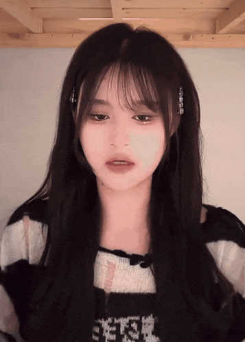 a girl wearing a black and white sweater with the letter e on the front