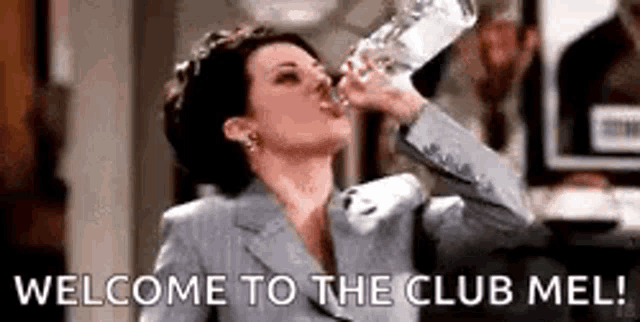 a woman in a suit is drinking water from a glass with the words `` welcome to the club mel '' .