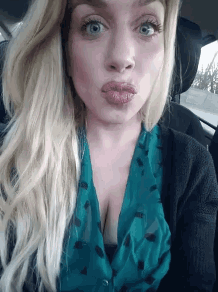 a woman in a car making a funny face with her mouth open