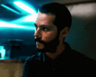 a man with a beard and mustache is looking to the side