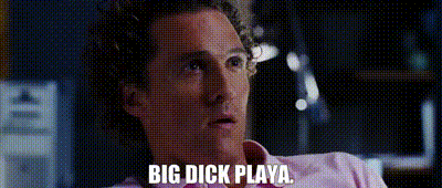 a man in a pink shirt is saying `` big dick playa '' while sitting down .