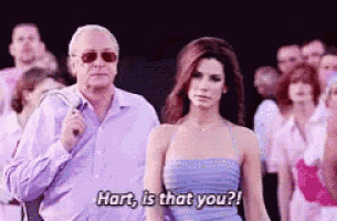 a man and a woman are standing next to each other and the woman is saying hart is that you .