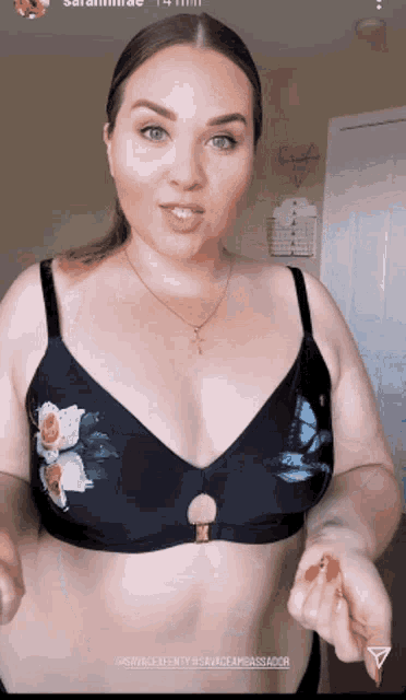 a woman is wearing a bikini top with a floral design