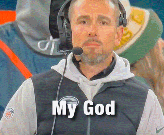 a man wearing headphones and a jacket that says nfl on it