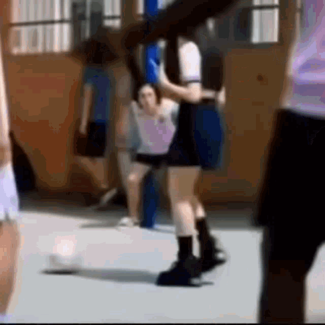 a group of girls are playing basketball on a court .