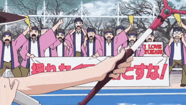 a group of people holding up a sign that says i love yukari