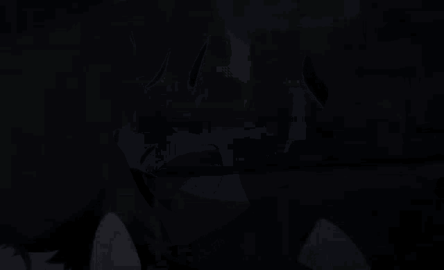 a close up of a person 's face with their eyes closed in a dark room .