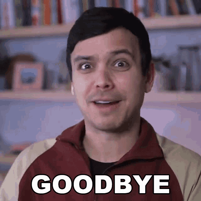 a man says goodbye in front of a shelf full of books
