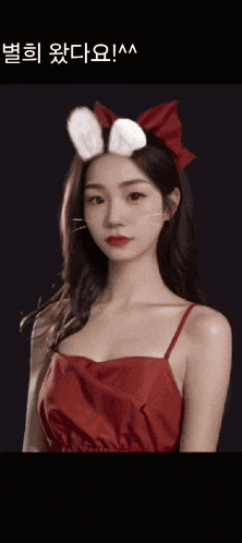 a girl in a red dress with bunny ears on her head
