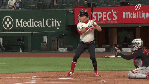 a baseball player getting ready to hit a ball in front of a medical city sign