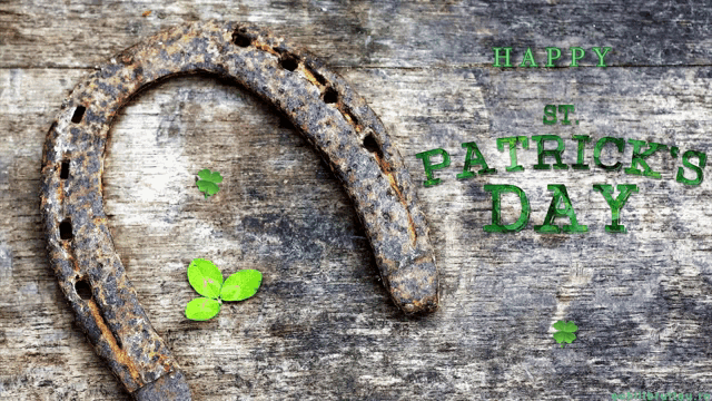 a horseshoe on a wooden surface with the words st. patrick 's day