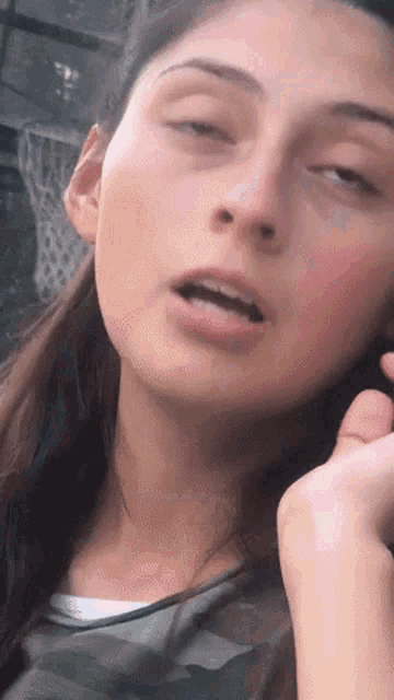 a close up of a woman 's face with a blurred background