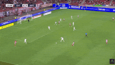 a soccer game is being played on a field with advertisements for shopflix and toiximan