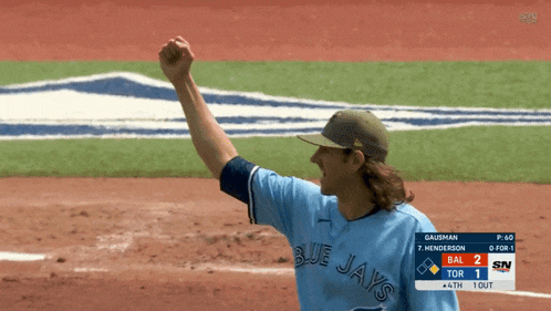 a baseball player wearing a blue jays jersey