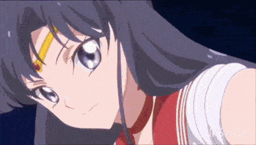 a close up of a girl 's face with a red and white uniform