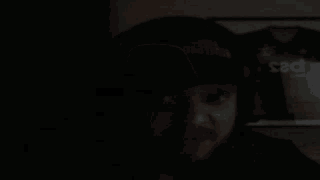 a dark room with a picture of a shirt that says sad