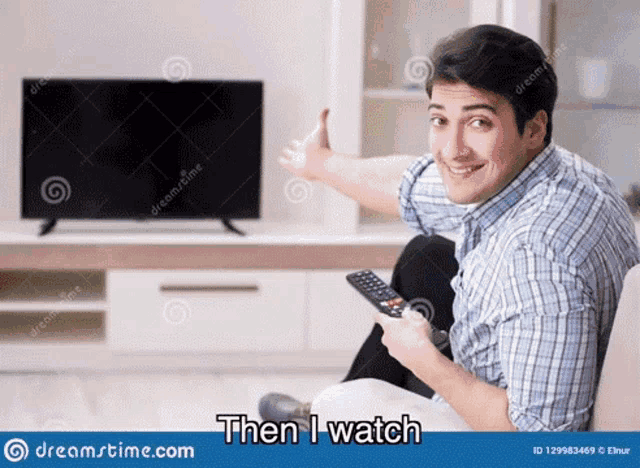 a man is sitting on a couch with a remote control in front of a flat screen tv .