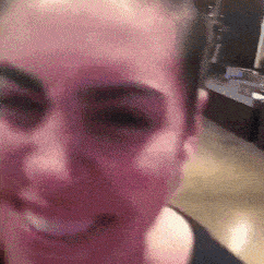 a close up of a woman 's face with a black shirt